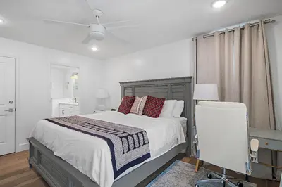 a bedroom with a bed and a ceiling fan at Beach & Bubbles in Santa Rosa Beach