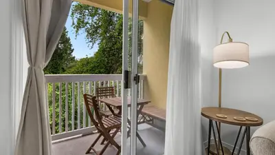 a room with a balcony with a table and chairs at Heron's Watch 6207 in Santa Rosa Beach