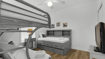a bedroom with a bunk bed and a tv at Heron's Watch 6207 in Santa Rosa Beach