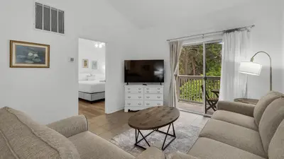 a living room with a couch and a tv at Heron's Watch 6207 in Santa Rosa Beach