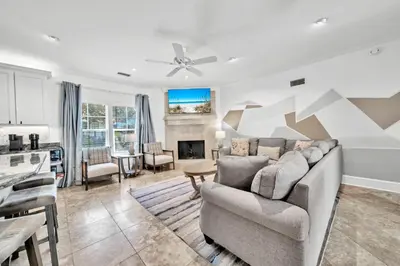 a living room with a couch and a kitchen at Saltaire-2 in Santa Rosa Beach