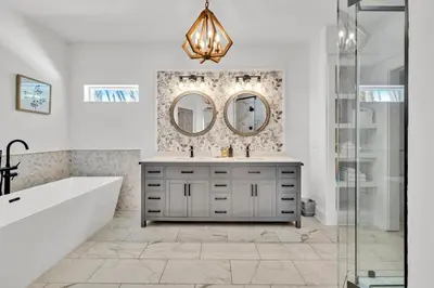 a bathroom with a tub and a sink and mirrors at Saltaire-2 in Santa Rosa Beach