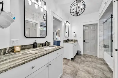 a bathroom with two sinks and a large mirror at Saltaire-2 in Santa Rosa Beach