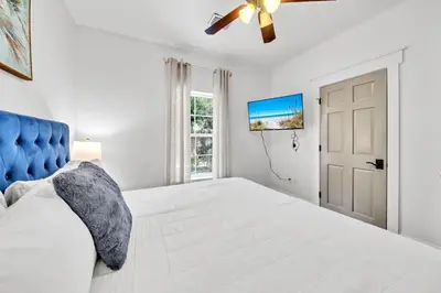 a bedroom with a large bed and a ceiling fan at Saltaire-2 in Santa Rosa Beach