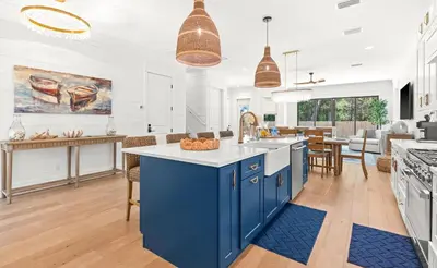a kitchen with blue cabinets and a blue island at Casa Al Mare in Santa Rosa Beach