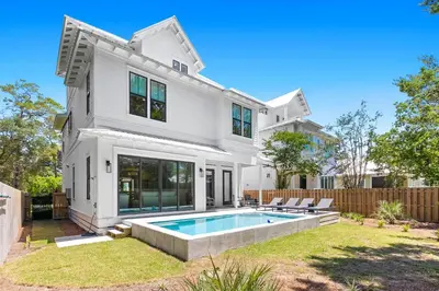 a white house with a swimming pool in the yard at Casa Al Mare in Santa Rosa Beach