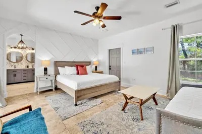 a bedroom with a bed and a ceiling fan at Saltaire in Santa Rosa Beach
