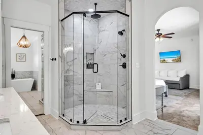 a shower with a glass door in a bathroom at Saltaire in Santa Rosa Beach