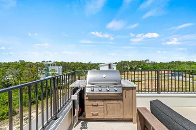 a grill on the balcony of a house at Above It All in Inlet Beach