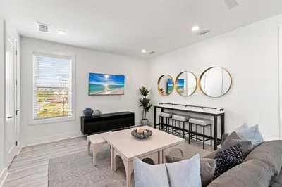 a living room with a couch and a table at Above It All in Inlet Beach