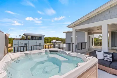 a hot tub on the balcony of a house at Above It All in Inlet Beach