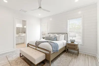 a white bedroom with a bed and a window at Above It All in Inlet Beach