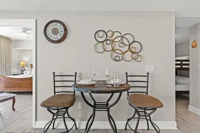 a dining room with a table and two chairs at Tidewater 2615 in Panama City Beach