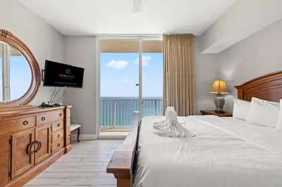 a bedroom with a large bed and a large window at Tidewater 2615 in Panama City Beach