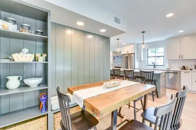 a kitchen and dining room with a wooden table and chairs at Walk to Laguna Beach PCB Home with Pool Near Gulf! in Panama City Beach