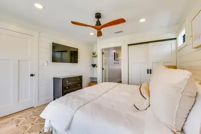 a bedroom with a bed and a ceiling fan at Walk to Laguna Beach PCB Home with Pool Near Gulf! in Panama City Beach
