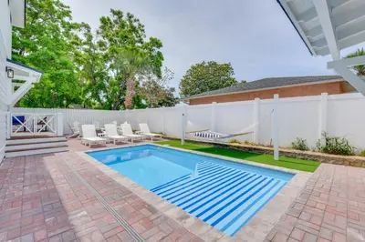 a backyard with a swimming pool and a white fence at Walk to Laguna Beach PCB Home with Pool Near Gulf! in Panama City Beach