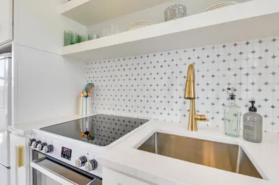 a kitchen with a sink and a counter top at Walk to Laguna Beach Modern Studio in PCB! in Panama City Beach