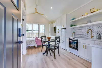 a kitchen with a table and chairs and a dining room at Walk to Laguna Beach Modern Studio in PCB! in Panama City Beach