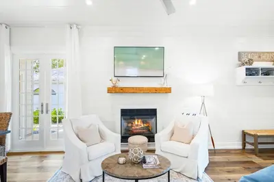 a living room with two chairs and a fireplace at 30A Seacrest Beach Access PoolGolf CartBikes in Inlet Beach
