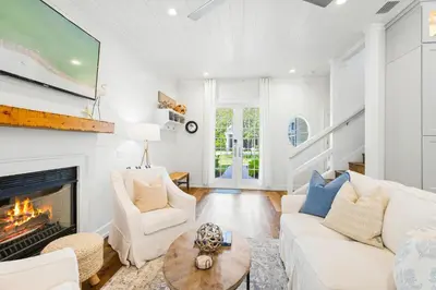 a living room with a white couch and a fireplace at 30A Seacrest Beach Access PoolGolf CartBikes in Inlet Beach