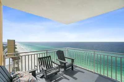 two chairs sitting on a balcony overlooking the ocean at Oceanfront Penthouse CornerUnit 1950sf with beach service in Panama City Beach