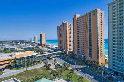 an aerial view of a city with tall buildings and the ocean at Oceanfront Penthouse CornerUnit 1950sf with beach service in Panama City Beach