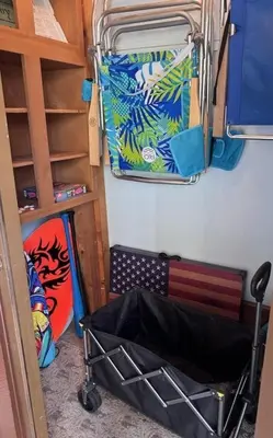 a room with a bed and a suitcase on the wall at Beachwalk 17B home in Panama City Beach