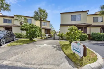 a house with a sign in front of a driveway at Beachwalk 17B home in Panama City Beach