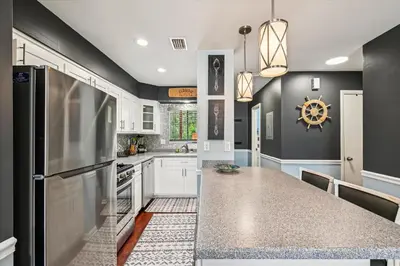 a kitchen with a counter top and a refrigerator at Beachwalk 17B home in Panama City Beach