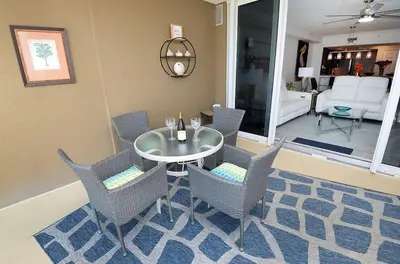 a dining room with a glass table and chairs at Emerald Beach 325 in Panama City Beach