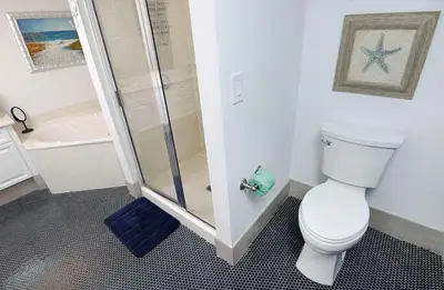 a bathroom with a shower and a toilet and a sink at Emerald Beach 325 in Panama City Beach