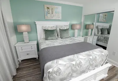 a bedroom with a large bed and two night stands at Emerald Beach 325 in Panama City Beach