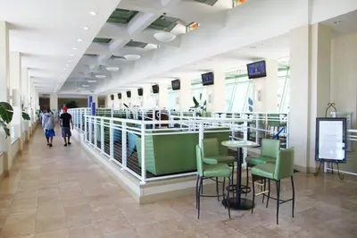 a lobby with a table and chairs in a building at Emerald Beach 325 in Panama City Beach