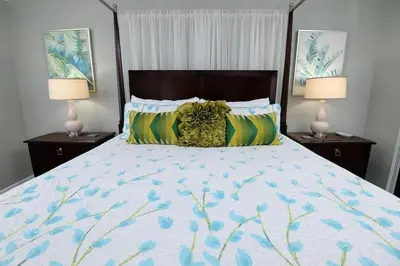 a bedroom with a large bed with two lamps at Emerald Beach 1130 in Panama City Beach