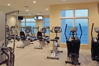 a gym with several treadmills and exercise bikes at Sterling Reef 902 in Panama City Beach