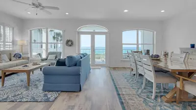 a living room with a blue couch and a table at Villas At Sunset Beach B201 in Panama City Beach