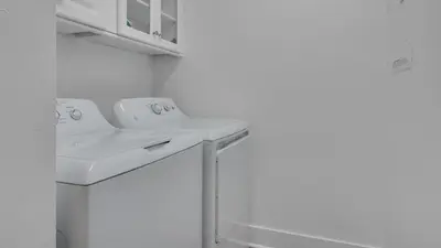a bathroom with a sink and a washing machine at Villas At Sunset Beach B201 in Panama City Beach