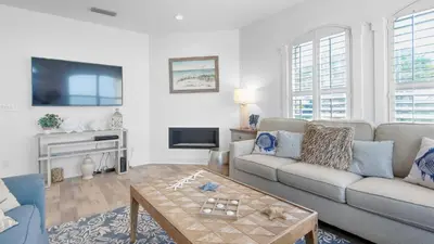 a living room with a couch and a table at Villas At Sunset Beach B201 in Panama City Beach
