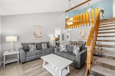 a living room with a couch and a table at Grey Zen in Panama City Beach