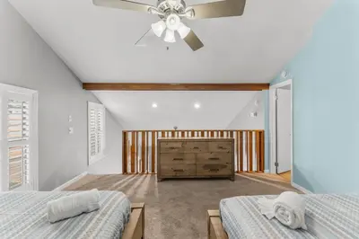 a bedroom with two beds and a ceiling fan at Grey Zen in Panama City Beach