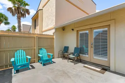 three blue chairs sitting on a patio in front of a house at Grey Zen in Panama City Beach