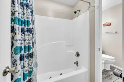 a bathroom with a shower curtain and a toilet at Beachside Villas 1022 in Santa Rosa Beach