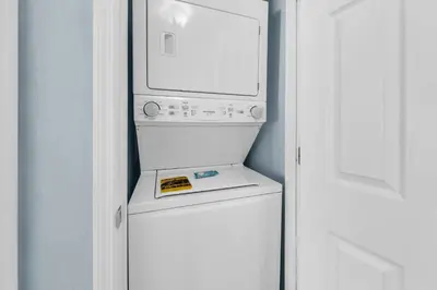 a white refrigerator with a microwave on top of it at Beachside Villas 1022 in Santa Rosa Beach