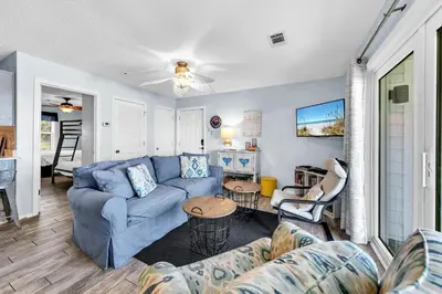 a living room with a blue couch and a table at Beachside Villas 1022 in Santa Rosa Beach