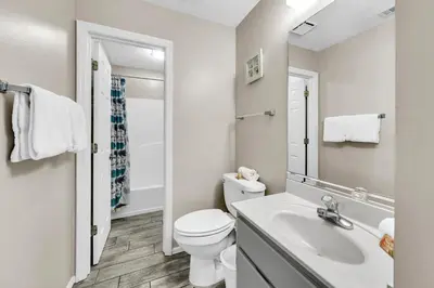 a white bathroom with a toilet and a sink at Beachside Villas 1022 in Santa Rosa Beach