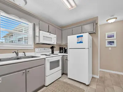 a kitchen with white appliances and a white refrigerator at Beachside Villas 1211 in Santa Rosa Beach