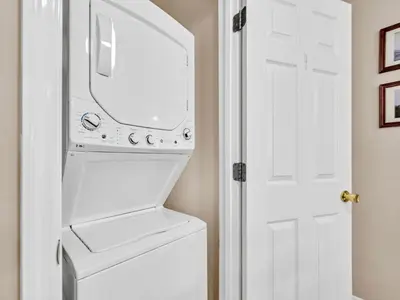 a white refrigerator freezer sitting next to a washer and dryer at Beachside Villas 1211 in Santa Rosa Beach