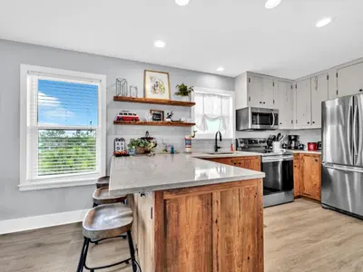 a kitchen with wooden cabinets and a stainless steel refrigerator at Beachside Villas 1131 in Santa Rosa Beach