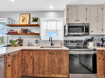 a kitchen with wooden cabinets and a sink at Beachside Villas 1131 in Santa Rosa Beach